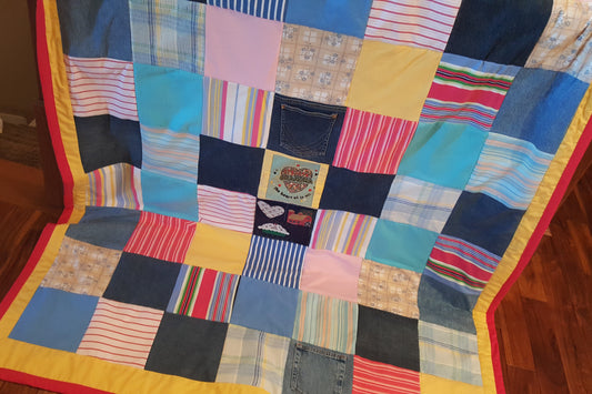 Patchwork quilt with colorful squares on a wooden floor